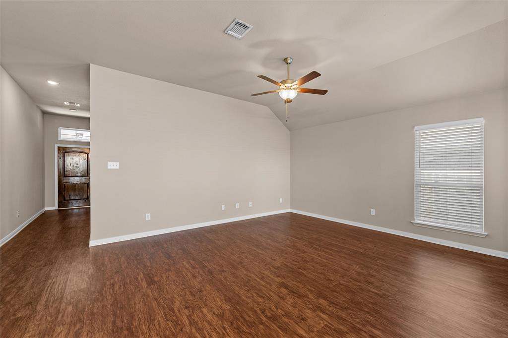 313 Branch Road Woodway, TX 76712 - Photo 3 of 16 wooden floor in an empty room with a window