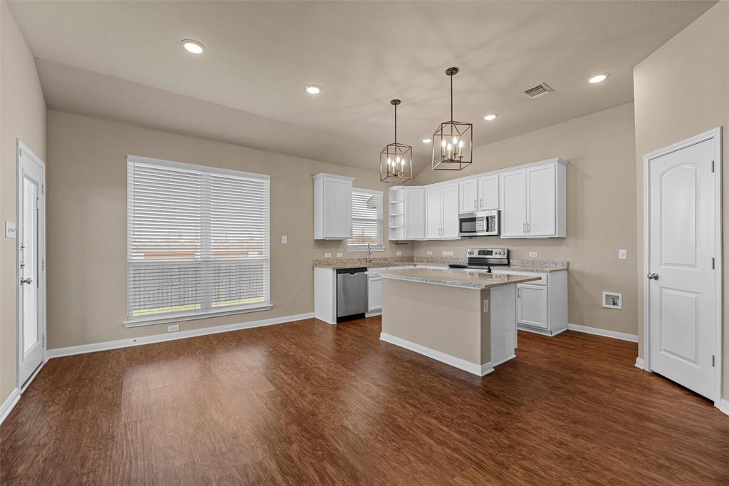 313 Branch Road Woodway, TX 76712 - Photo 4 of 16 a large kitchen with hardwood floor a window and appliances