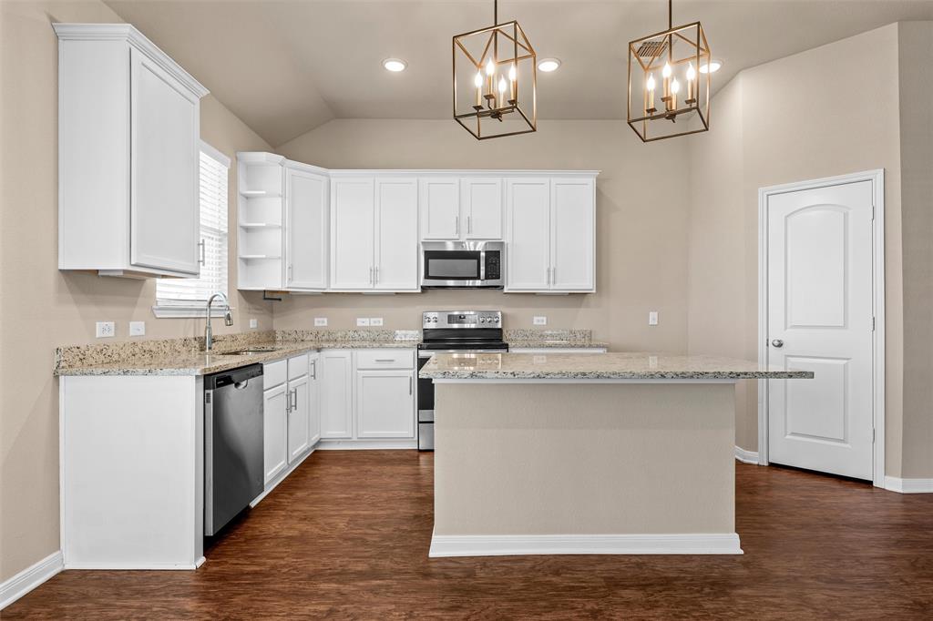 313 Branch Road Woodway, TX 76712 - Photo 5 of 16 a kitchen with stainless steel appliances granite countertop a stove top oven a sink dishwasher and a microwave oven on the wooden floor
