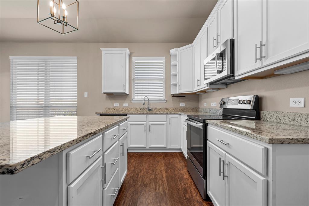 313 Branch Road Woodway, TX 76712 - Photo 6 of 16 a kitchen with stainless steel appliances granite countertop a sink and dishwasher a stove top oven with white cabinets