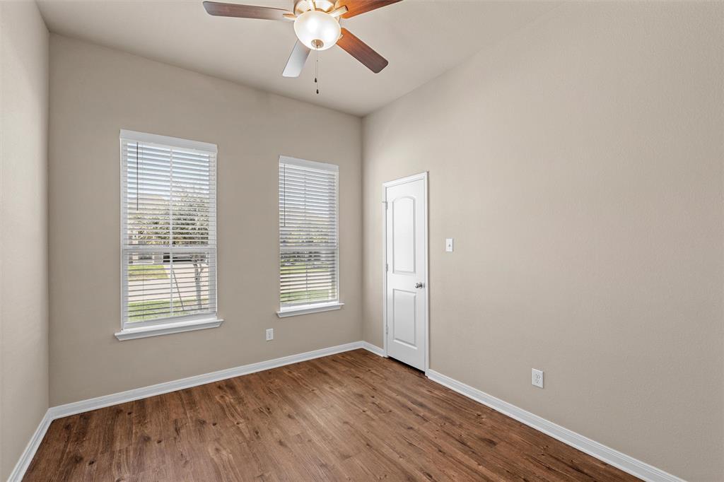 313 Branch Road Woodway, TX 76712 - Photo 7 of 16 a view of an empty room with wooden floor and a window