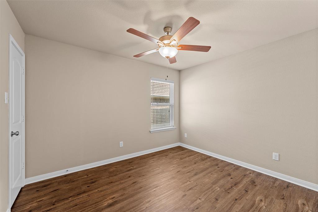 313 Branch Road Woodway, TX 76712 - Photo 8 of 16 a view of a room with wooden floor and fan