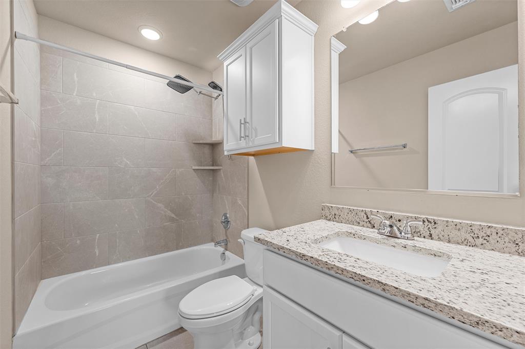 313 Branch Road Woodway, TX 76712 - Photo 9 of 16 a bathroom with a granite countertop sink a toilet and shower