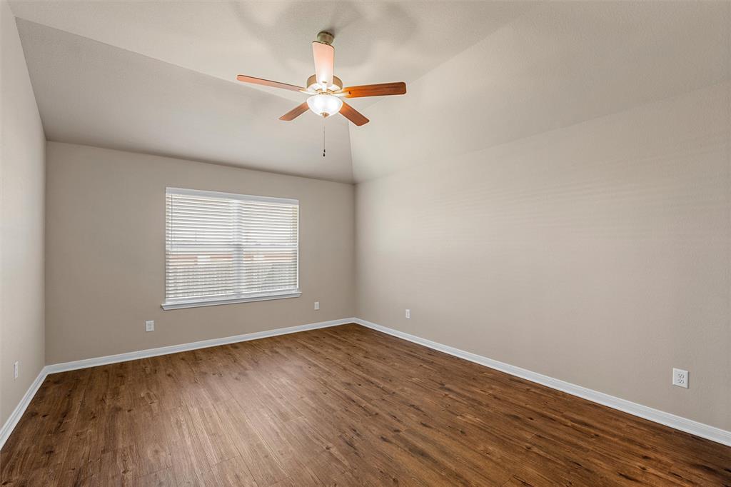 313 Branch Road Woodway, TX 76712 - Photo 10 of 16 an empty room with wooden floor fan and windows