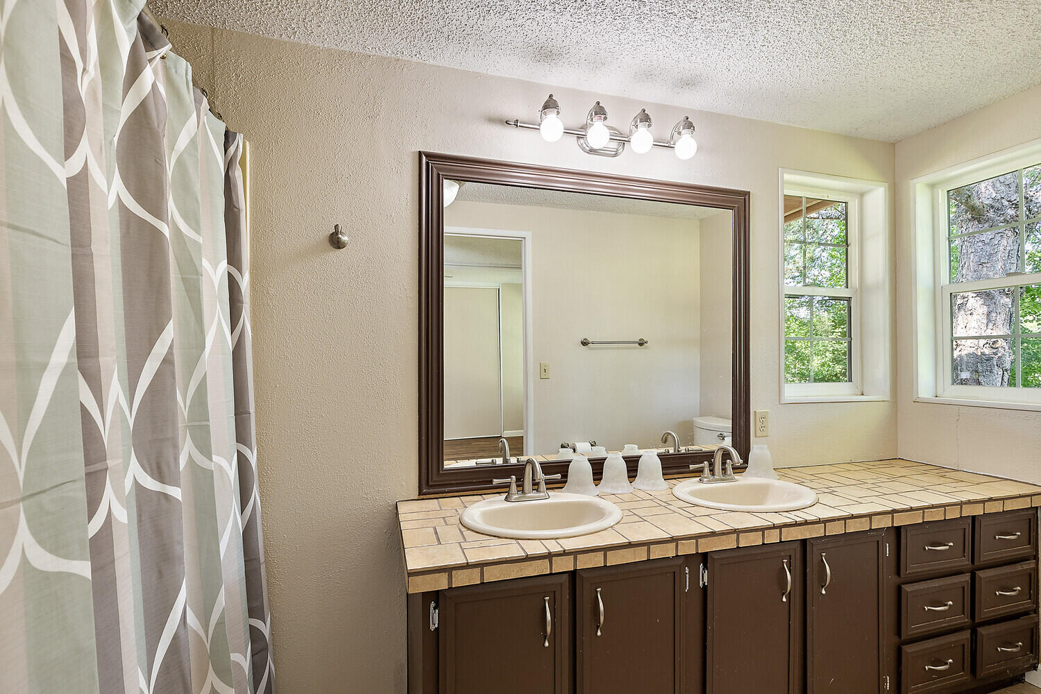 10710 Meadows Road White City, OR 97503 - Photo 16 of 46 a bathroom with a granite countertop sink and a mirror