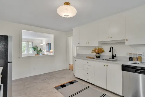 a kitchen with stainless steel appliances granite countertop a sink stove and cabinets