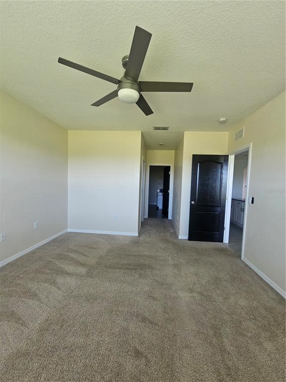 2853 Grandbury Grove Road Lakeland, FL 33811 - Photo 14 of 25 a view of an empty room with a ceiling fan