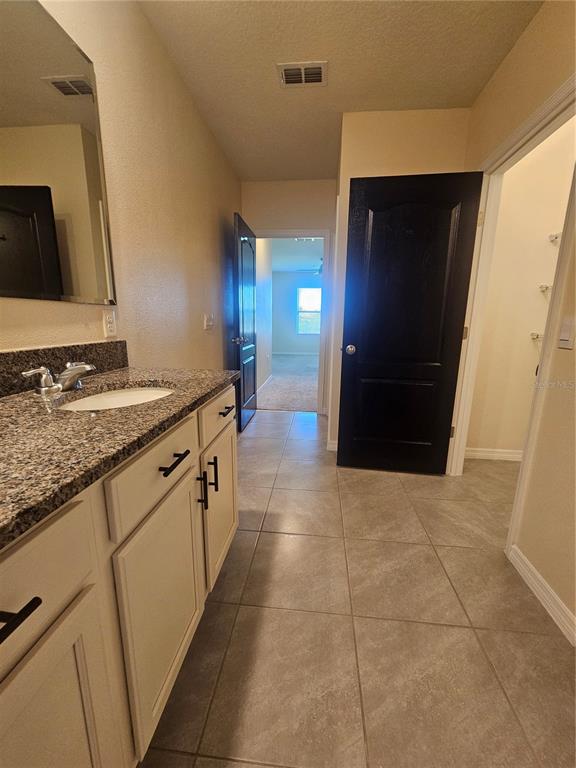 2853 Grandbury Grove Road Lakeland, FL 33811 - Photo 22 of 25 a bathroom with a sink a toilet and a mirror