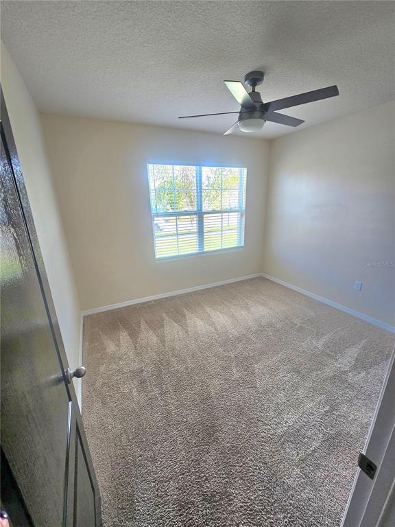 2853 Grandbury Grove Road Lakeland, FL 33811 - Photo 3 of 25 a view of an empty room with a window