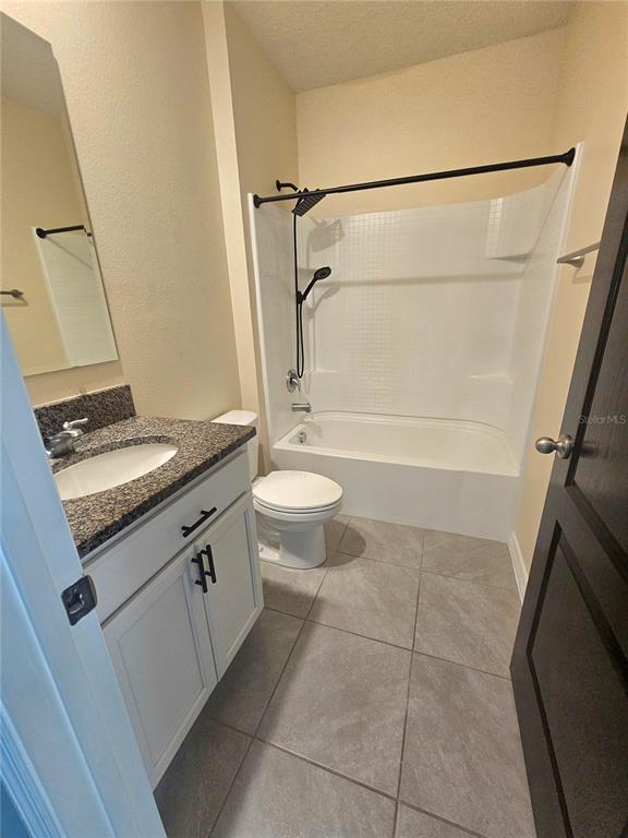 2853 Grandbury Grove Road Lakeland, FL 33811 - Photo 4 of 25 a bathroom with a granite countertop sink toilet and shower