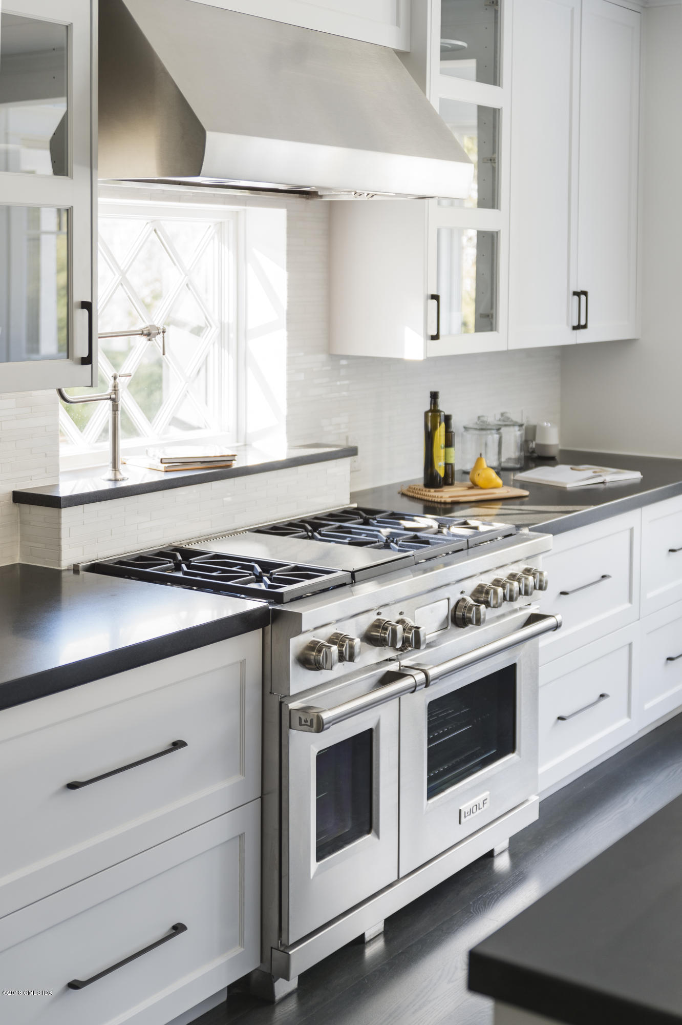 121 Lockwood Road Riverside, CT 06878 - Photo 12 of 40 a stove top oven sitting inside of a kitchen
