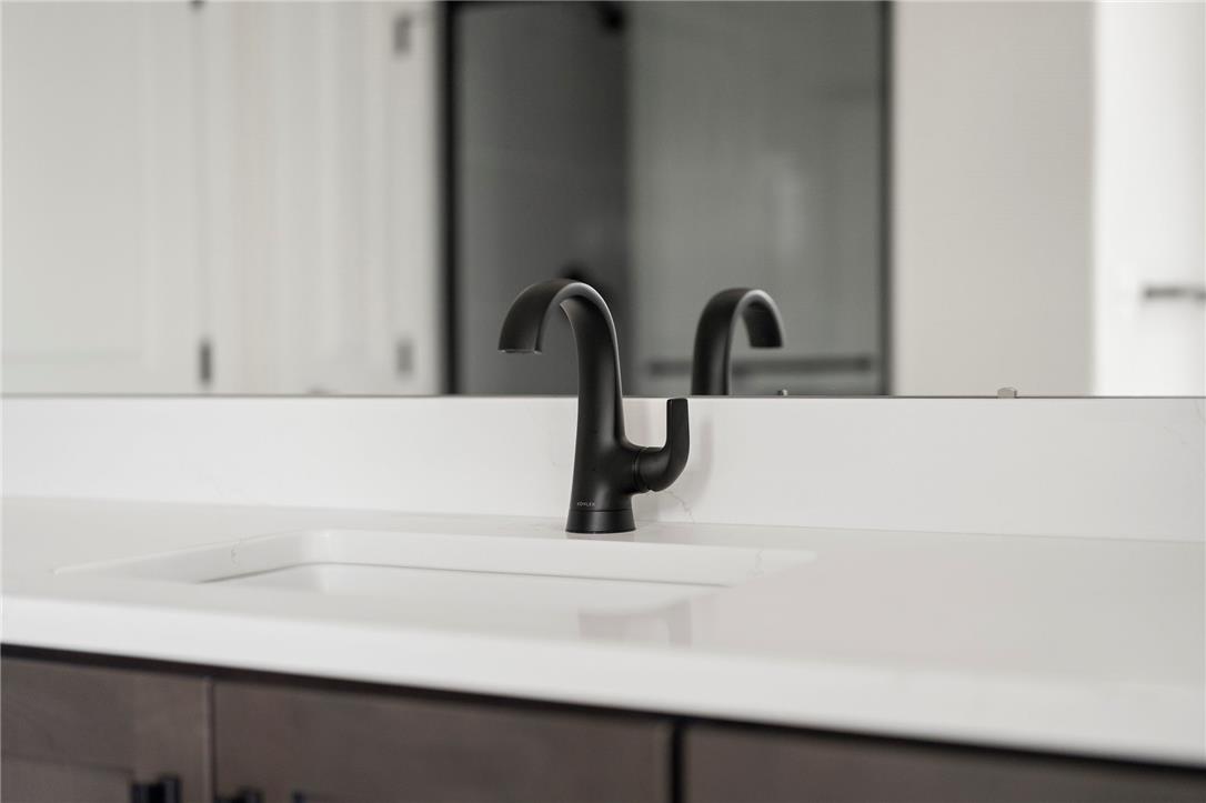 Hottle Road Quakertown, PA 18951 - Photo 51 of 59 A modern black gooseneck faucet accents the clean lines of this crisp white vanity countertop.