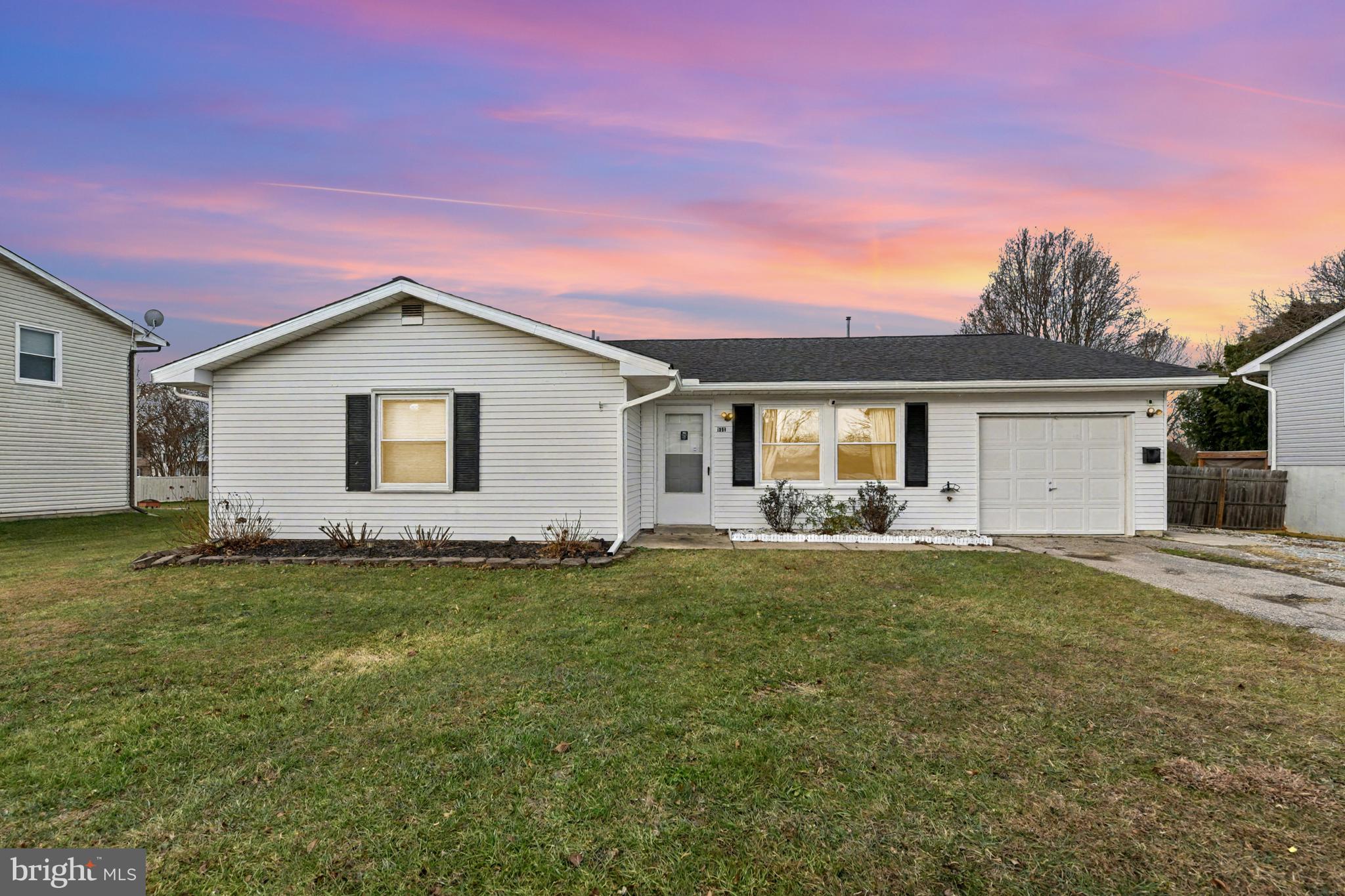 a view of a house with a backyard