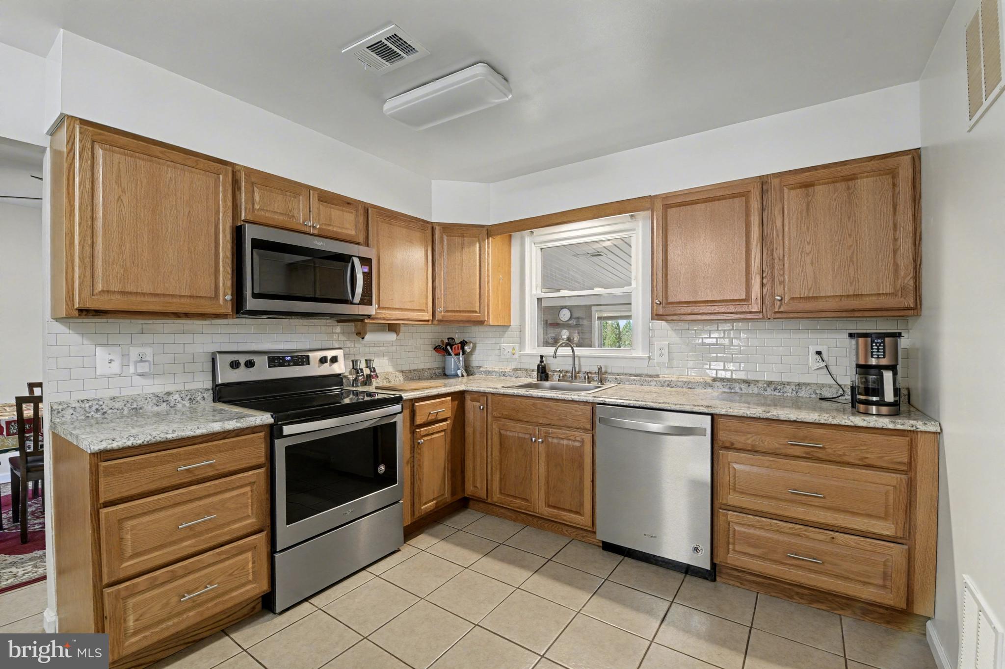1804 Harbinger Trail Edgewood, MD 21040 - Photo 11 of 29 a kitchen with granite countertop cabinets stainless steel appliances and a window