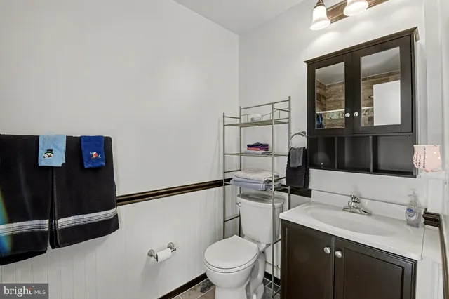a bathroom with a toilet sink and mirror