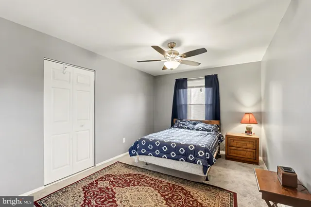 a bedroom with a bed chandelier and a window