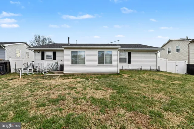 a front view of a house with a garden and yard