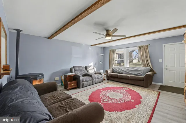 a bedroom with furniture and wooden floor