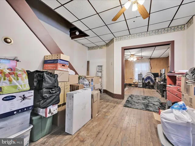 a view of a hallway and a livingroom with furniture