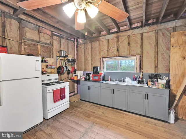 a kitchen with stainless steel appliances a sink window and cabinets