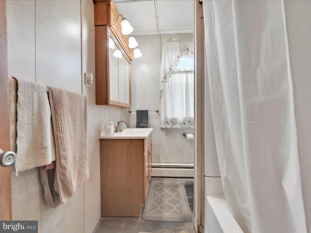 a bathroom with a sink a mirror and a shower