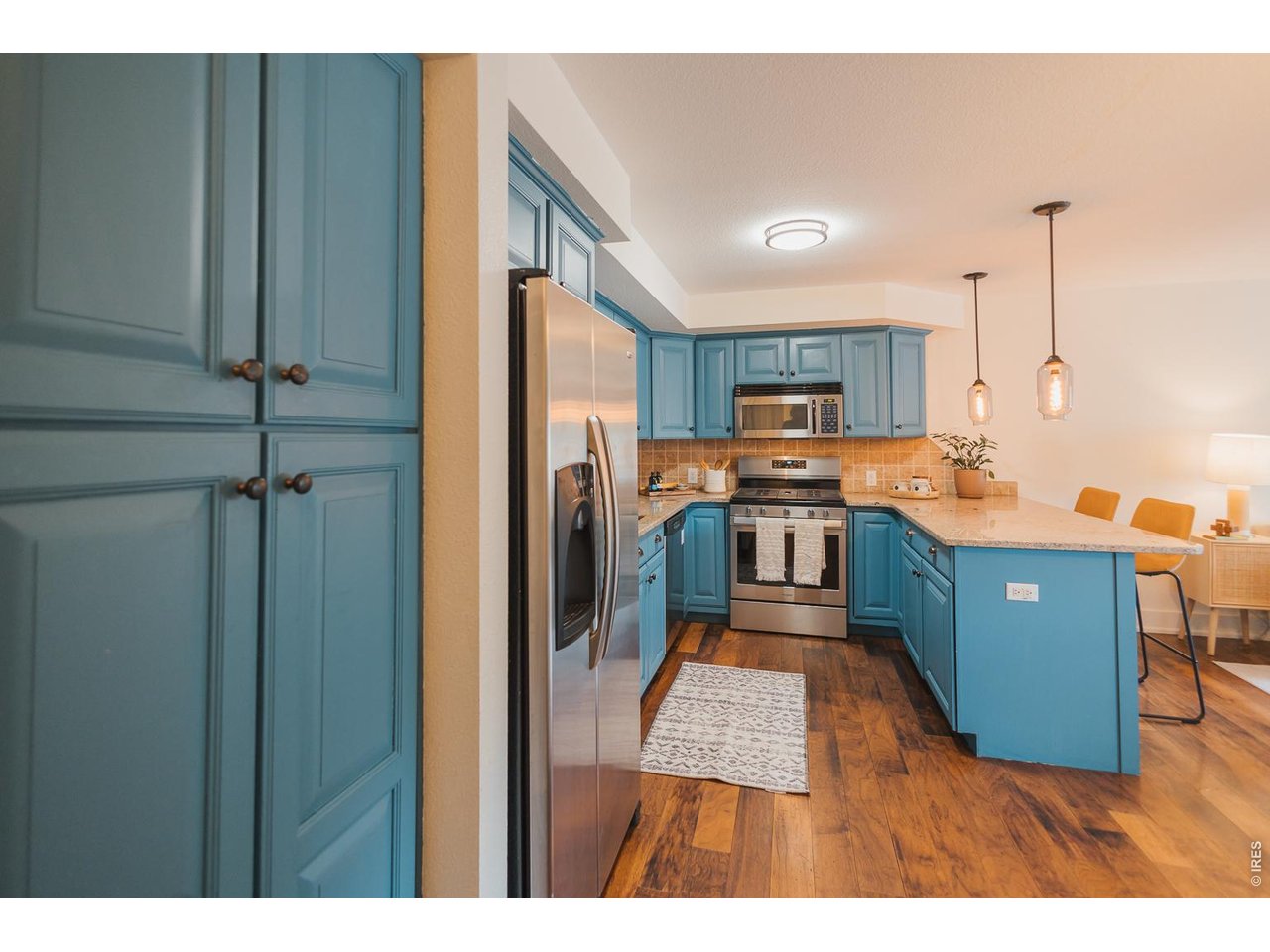 233 North Meldrum Street Fort Collins, CO 80521 - Photo 11 of 46 a kitchen with stainless steel appliances granite countertop a refrigerator a stove and a sink