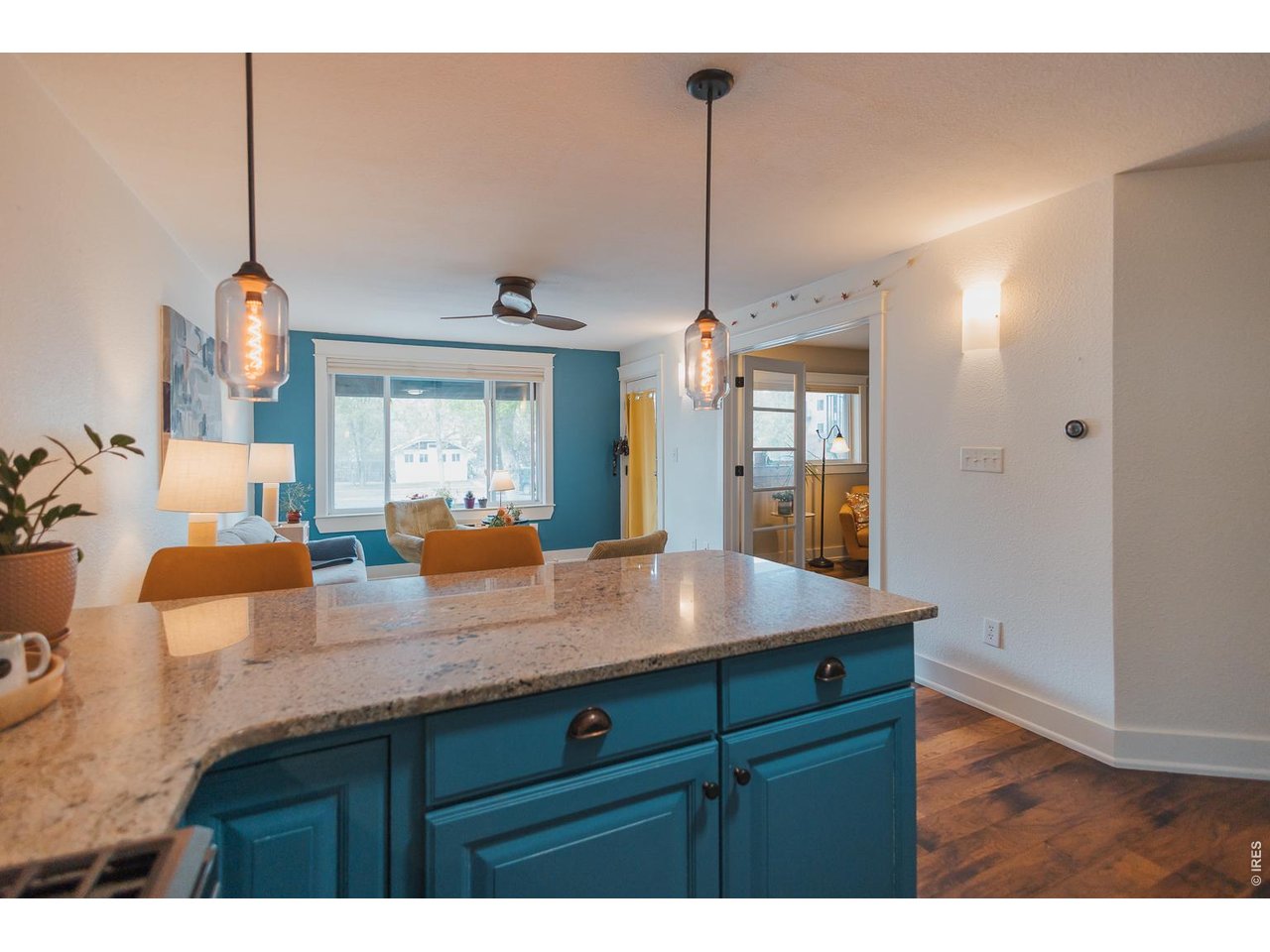 233 North Meldrum Street Fort Collins, CO 80521 - Photo 16 of 46 a view of kitchen island a chandelier furniture and windows