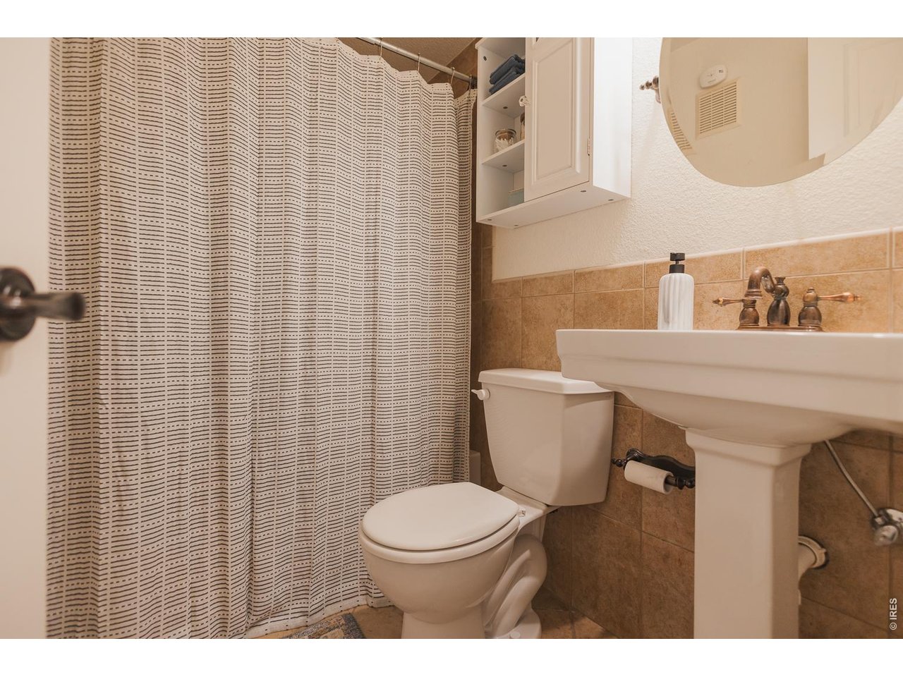 233 North Meldrum Street Fort Collins, CO 80521 - Photo 31 of 46 a bathroom with a sink a toilet and a mirror