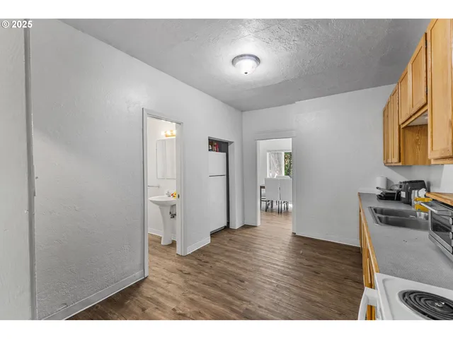 a kitchen view with wooden floor and a sink