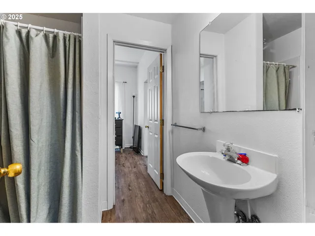 a bathroom with a sink a mirror and a shower