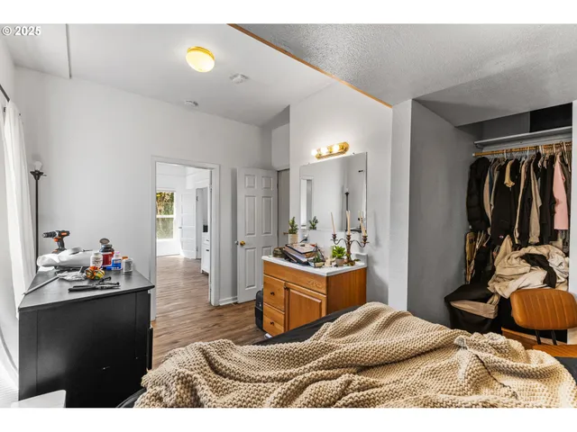 a living room with furniture a flat screen tv and gym equipment