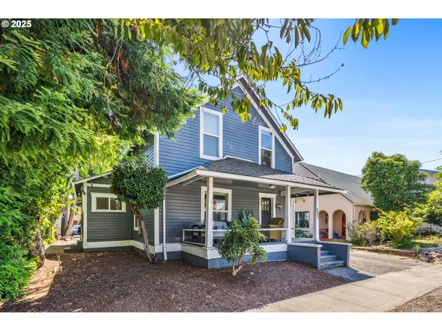 a porch with a table and chairs