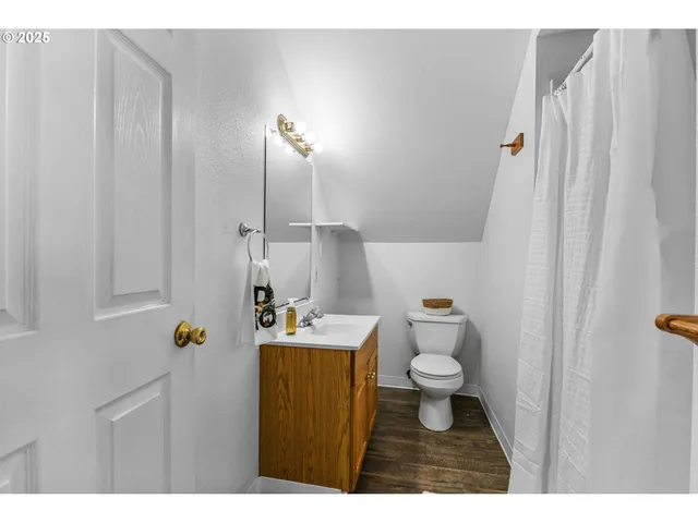 a bathroom with a toilet a sink and a mirror