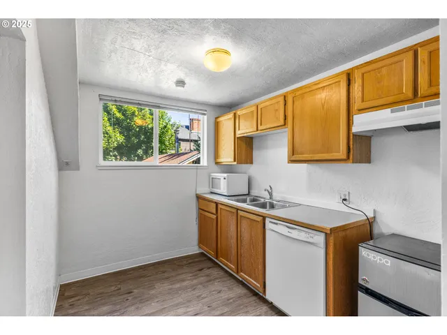 a kitchen with a sink cabinets and window