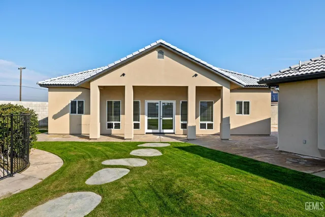 a kitchen with granite countertop a sink and a stove