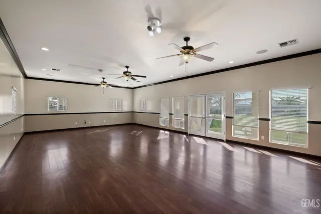 a view of a swimming pool with a lounge chair and palm trees