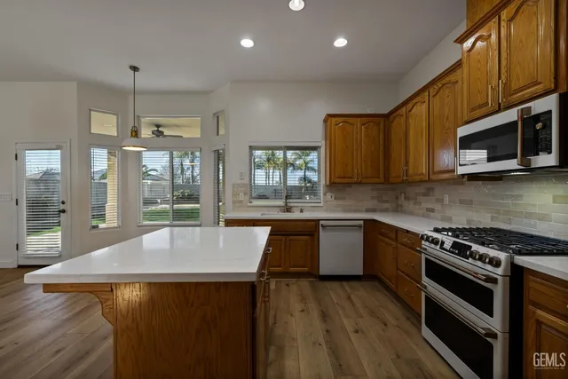 a stove top oven sitting inside of a kitchen