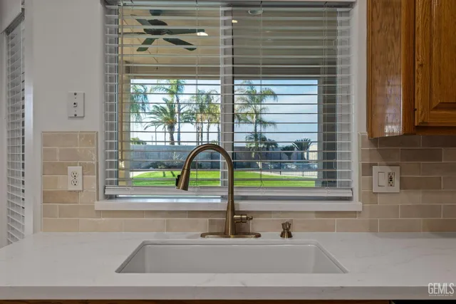 a bathroom with a granite countertop shower and a sink