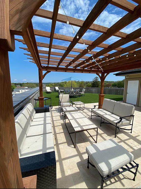 226 New York Avenue, Unit 302 Huntington, NY 11743 - Photo 11 of 11 a roof deck with a table and chairs