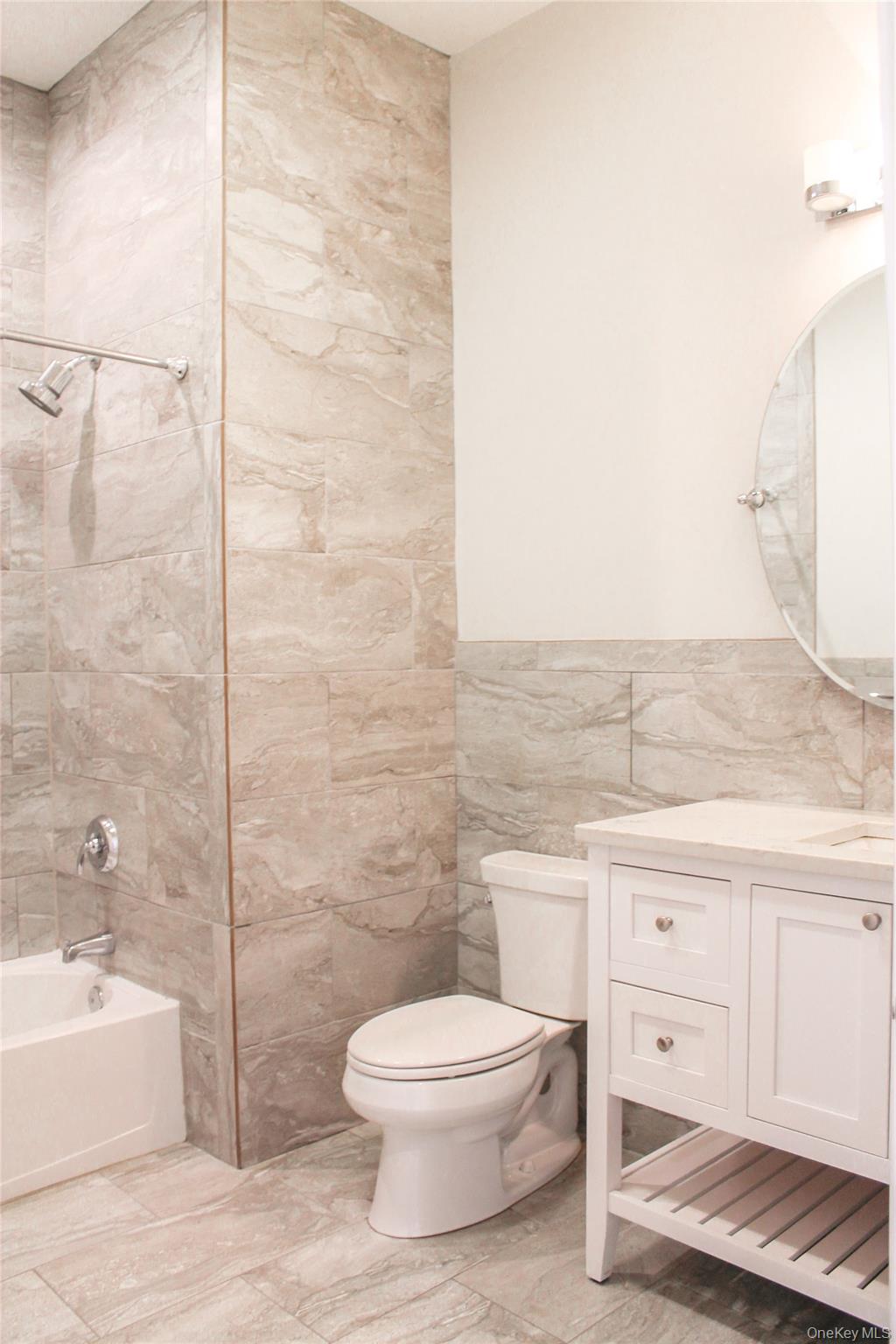 226 New York Avenue, Unit 302 Huntington, NY 11743 - Photo 7 of 11 a bathroom with a toilet a sink and bathtub