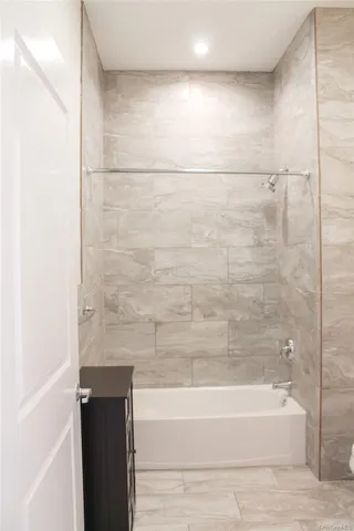 a bathroom with a bathtub and shower