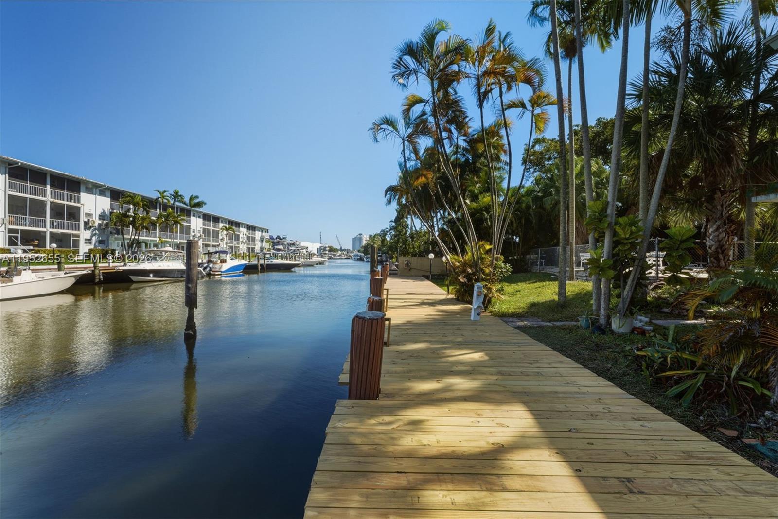 645 Northeast 77th Street, Unit 17 Miami, FL 33138 - Photo 11 of 12 a view of a lake with a palm trees