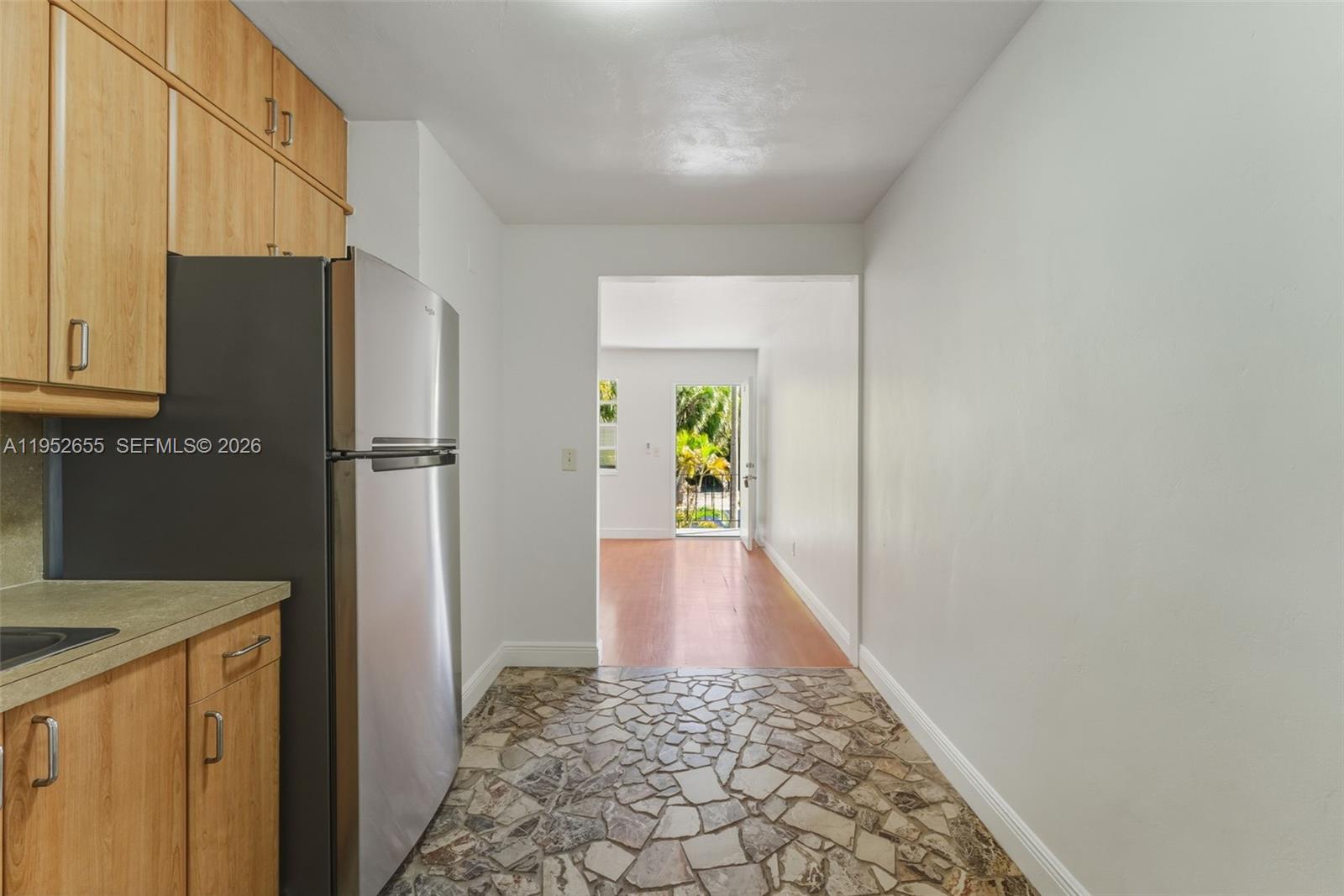 645 Northeast 77th Street, Unit 17 Miami, FL 33138 - Photo 7 of 12 a view of hallway with wooden floor