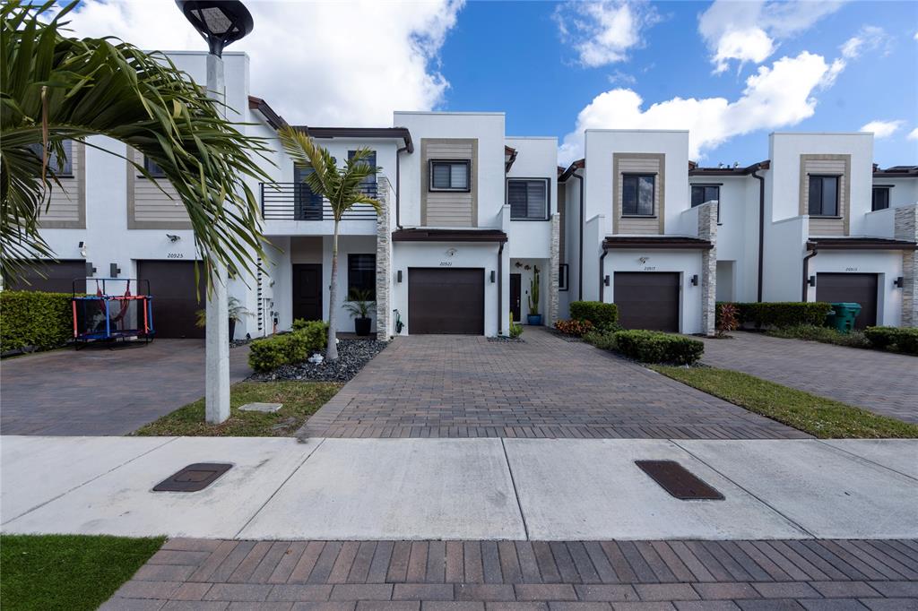 20920 Northeast 8th Avenue Miami, FL 33162 - Photo 16 of 19 a front view of a house with a yard
