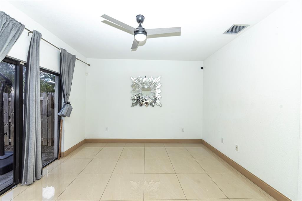 20920 Northeast 8th Avenue Miami, FL 33162 - Photo 4 of 19 a view of a room with rack on the wall