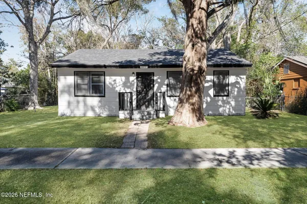 a front view of house with a garden