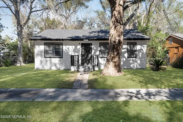 a front view of house with a garden