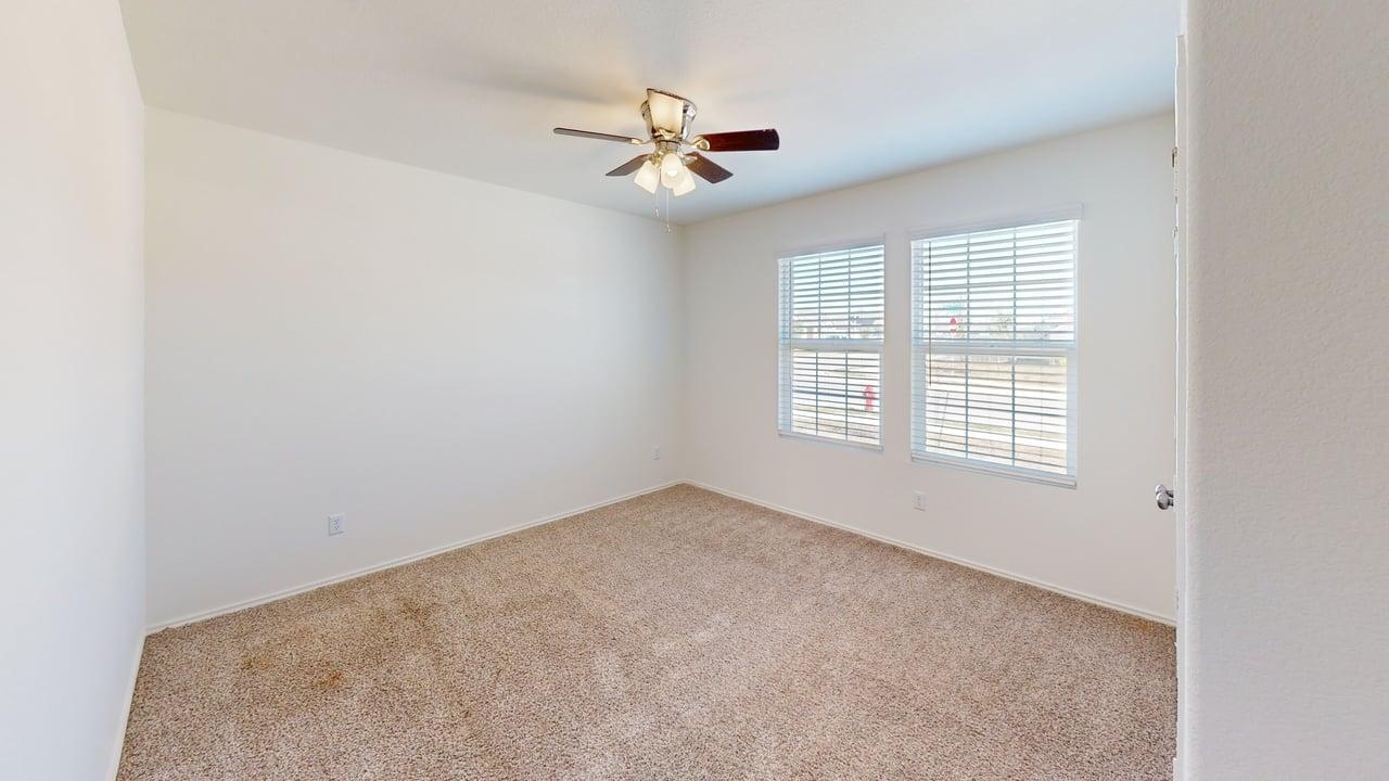 1000 Berryhack Court Hutto, TX 78634 - Photo 15 of 22 Carpeted empty room with baseboards and ceiling fan