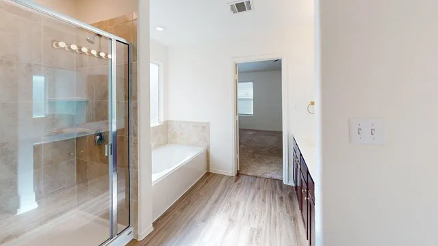 a bathroom with a bathtub and a shower