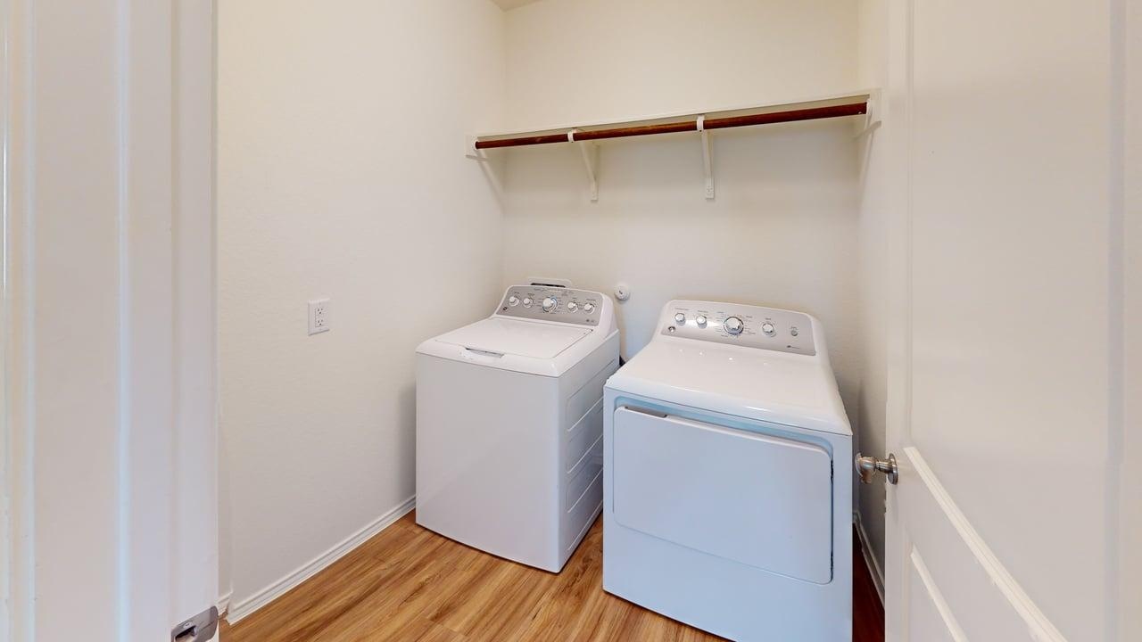1000 Berryhack Court Hutto, TX 78634 - Photo 18 of 22 Laundry area featuring light wood-style flooring and washing machine and dryer